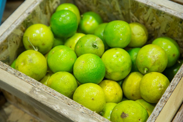 Green Lemon fresh in Wooden box, Thailand Market.