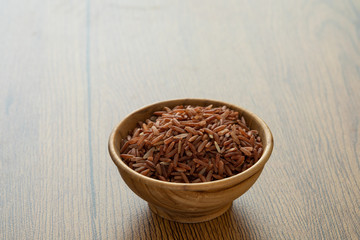brown rice for healthy wood bowl on wood background