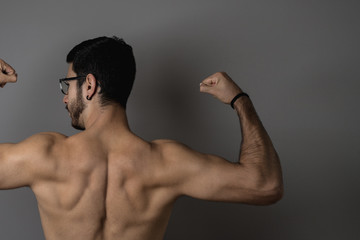 Muscular young man posing with definition