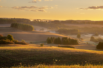  fields and meadows on a magnificent misty and sunny morning. landscape picture resembling Italian Tuscany. Autumn, Poland, Drawsko Lake District