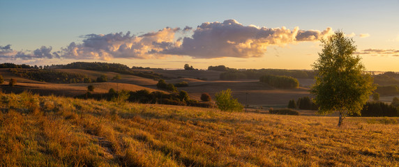 panorama of fields and meadows on a magnificent misty and sunny morning. landscape picture resembling Italian Tuscany. Autumn, Poland, Drawsko Lake District