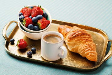 Breakfast setting with coffee and croissant