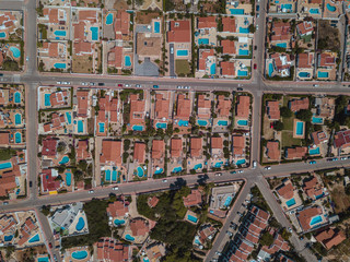 Aerial bird's eye view drone of boat docked in mediterranean tropical beach with turquoise - sapphire waters