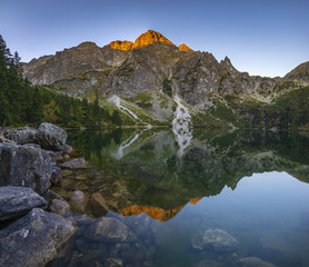 Panorama of a mountain lake during sunrise - Morskie Oko, Tatra Mountains, Poland