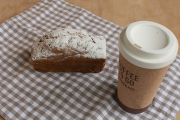 Sweet cake and coffee to go. Homemade bun.