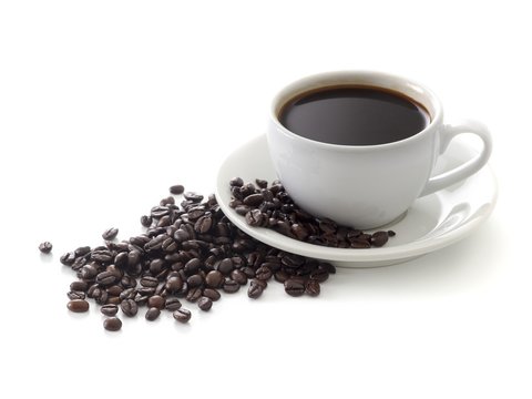 Black coffee in cup with beans