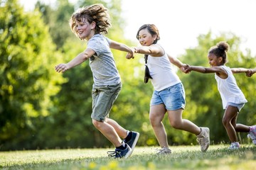 Children holding hands and running