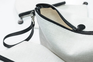 Closeup of white bag zipper.