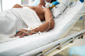 Close up of patient hand with intravenous drip and pulse oximeter sensor on finger