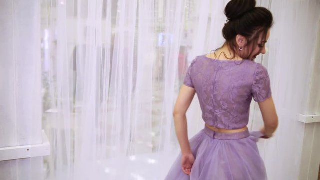 girl demonstrates bridesmaid outfit at a wedding exhibition