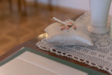 Wedding rings lie on a beautifully prepared pillow for the wedding ceremony. Concept: wedding and wedding ceremony