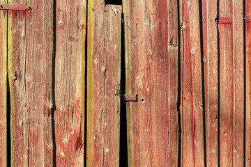 Old weathered red wooden doors of a shed