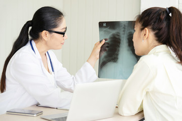 Female doctor talking to patient.Doctor and patient discussing something while sitting at the table . Medicine and health care concept. Doctor and patient
