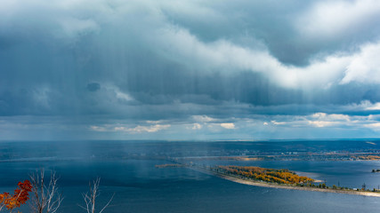 clouds and rain over the river