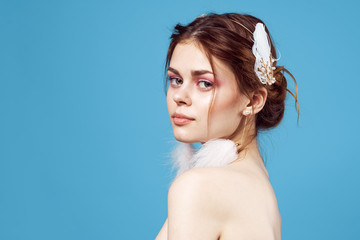 woman with an ornament in her hair hairpin earrings in the form of feathers