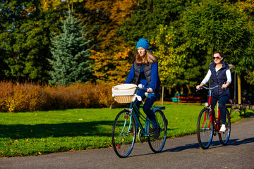 Healthy lifestyle - people riding bicycles in city park