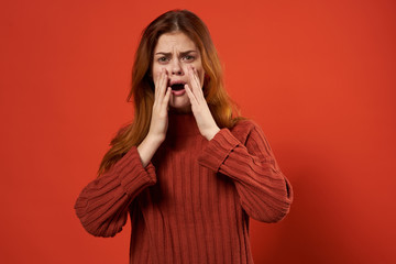 red background shocked woman in a sweater