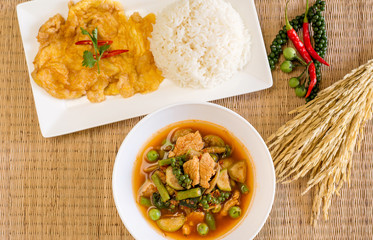 Jungle hot and spicy curry with pork and omelet,cooked rice,Thai food style,Top view © gballgiggs