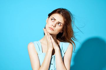 woman on a blue background folded her arms near...