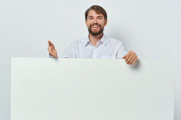 man in blue shirt shows on a sheet of paper