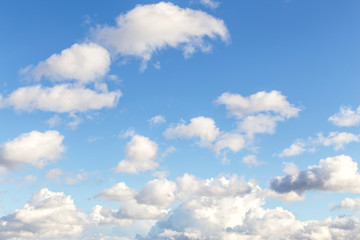 Cumulus white clouds against blue sky background	