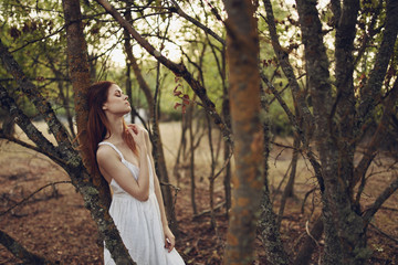 beautiful woman on nature green leaves trees