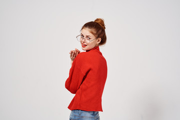 beautiful woman in a sweater and glasses turned her head back
