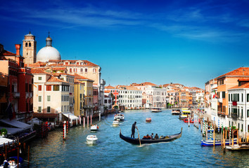 Fototapeta na wymiar Grand canal with Gondolas and boats at sunny day, Venice, Italy, retro toned
