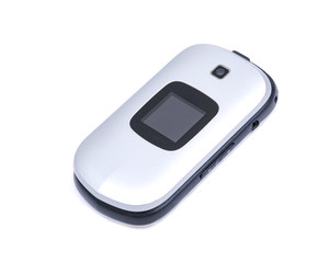 Old used flip cell phone isolated on white background