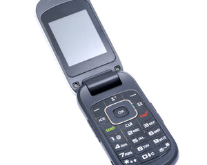 Old used flip cell phone isolated on white background