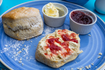 english cream tea with scones, clotted cream, marmelade and tea
