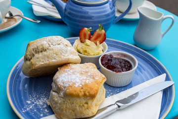 english cream tea with scones, clotted cream, marmelade and tea