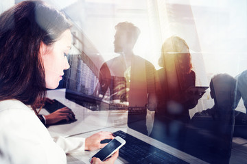 Business people work together in office with workstation in the foreground. Concept of teamwork and...