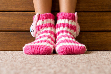 Obraz na płótnie Canvas Funny pink socks on the legs of a little girl