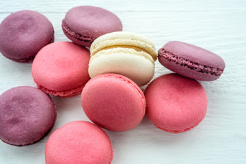 Sweet macarons on a white background. Trendy cakes.