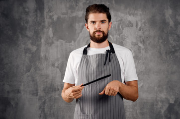 man in an apron and a comb in his hand