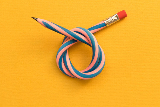 Flexible pencil . Isolated on yellow background