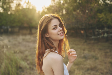 beautiful red-haired woman on nature