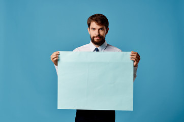 handsome man with a beard holding a sheet of paper in his hands