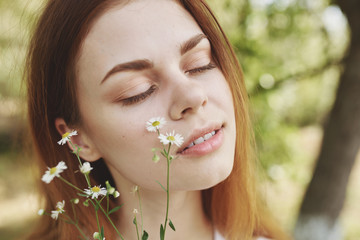 woman with wildflowers eyes closed
