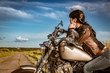 Biker girl sitting on motorcycle