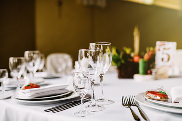  Close-up of folded napkin and empty glasses. 