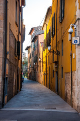 Fototapeta na wymiar Narrow street with yellow buildings and old street light