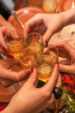 Close shot of girls clink glasses with shots
