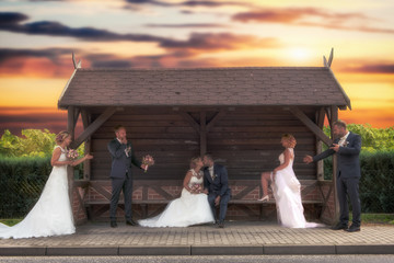Fototapeta premium Bride and groom were photographed several times in a bus stop. Concept: wedding and couple shooting