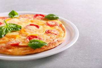 Fresh homemade pizza with basil on top