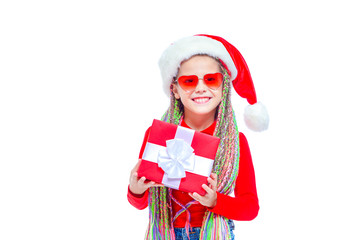 Girl in Santa's hat. Portrait of little cute girl holding box of Christmas present, Small girl hug her gift with happy and fun expression isolated on white background. Holiday gift