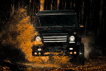 Mud and water splash in off-road racing. Off the road travel on mountain road. Track on mud. Expedition offroader. 4x4 Off-road suv car. Offroad car. Safari. Tires in preparation for race. © Volodymyr