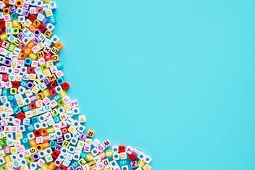English letter beads on blue background for learning concept