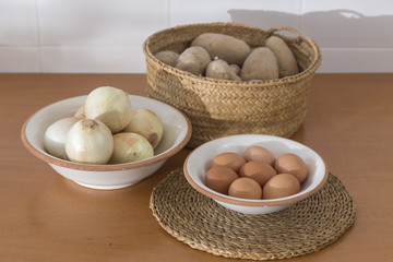 basic foods on the kitchen table, eggs, onions and potatoes